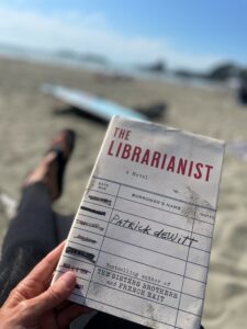 Image of the book The Librarianist by Patrick deWitt at the beach.