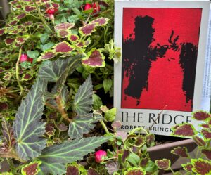 The Ridge book sitting in a a garden.