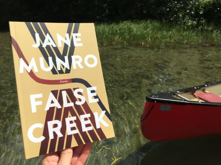 Image of the book Flase Creek by a creek and red canoe.