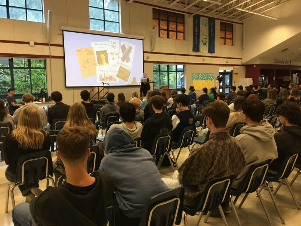 author presents to high school students with a power point screen of her book images
